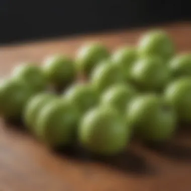 Fresh amla fruit on a wooden surface showcasing its vibrant green color.