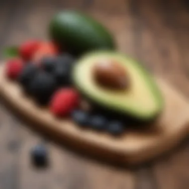 Sliced avocado and berries on a wooden board